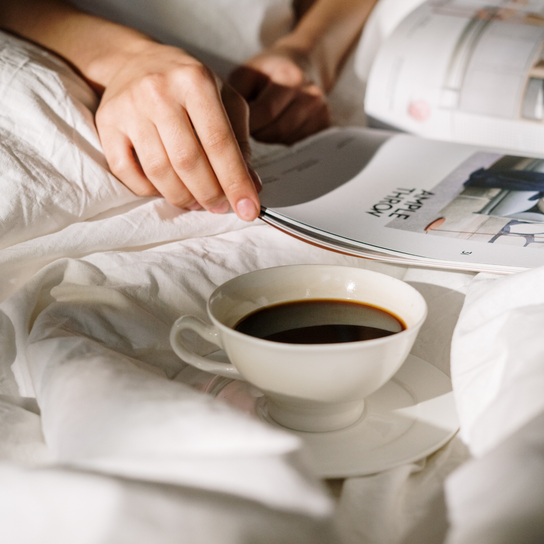 How to create a morning routine that actually sticks - Header - Picture of woman on bed with a cup of coffee
